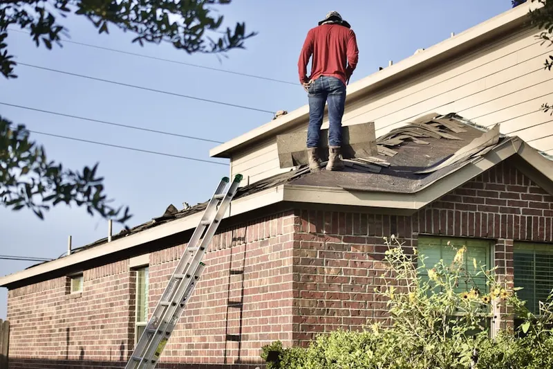 Professional roofer working on a residential roof in Foxhall Village